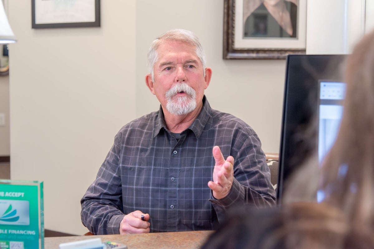 Patient discussing dental information with the front desk team in Chesapeake, Virginia.